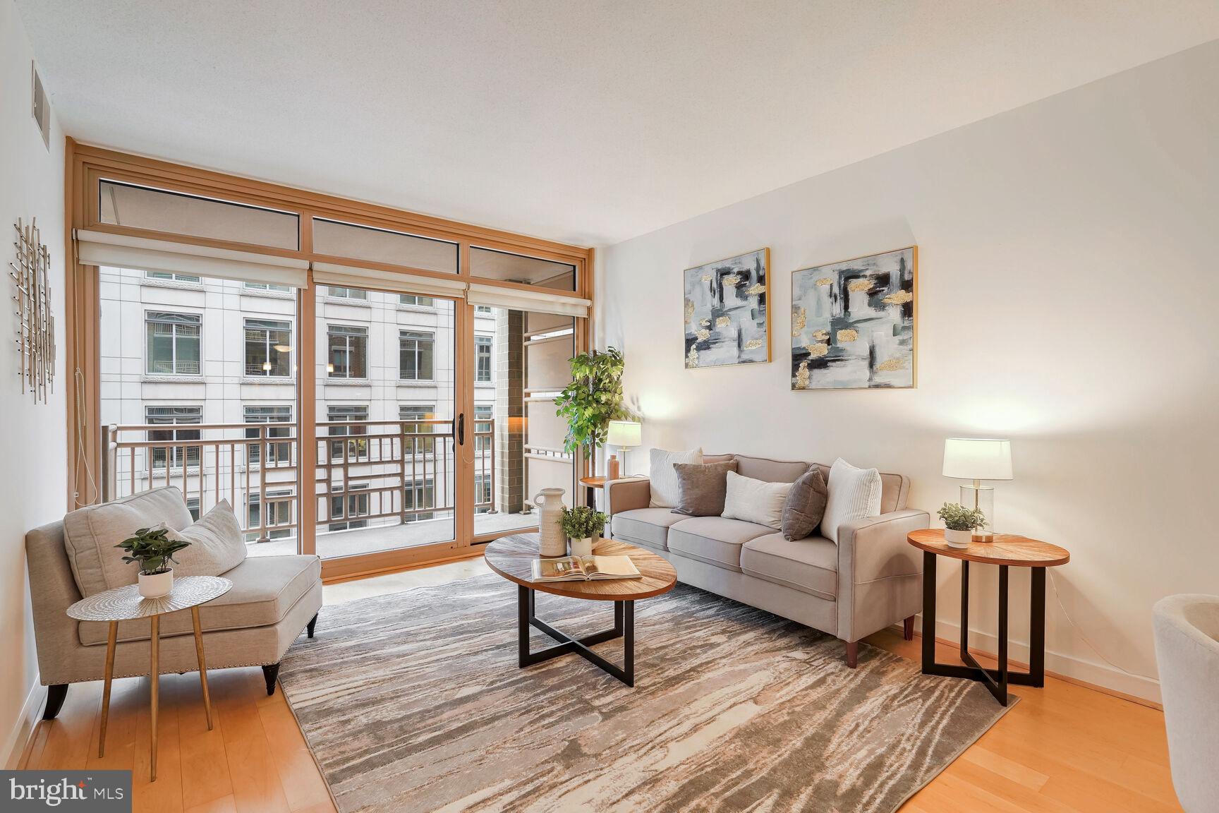 a living room with furniture and a potted plant