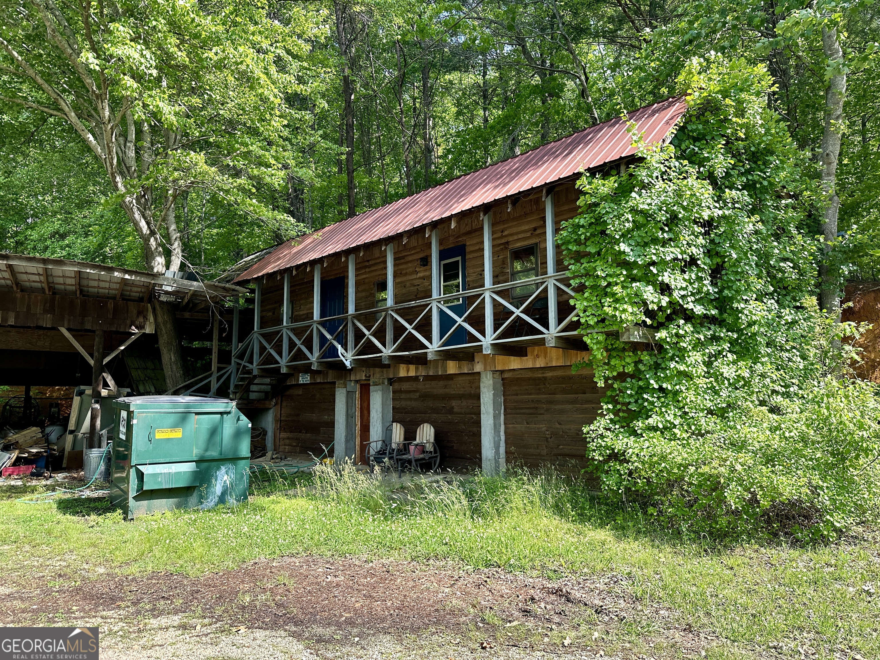 a view of house with backyard and outdoor seating