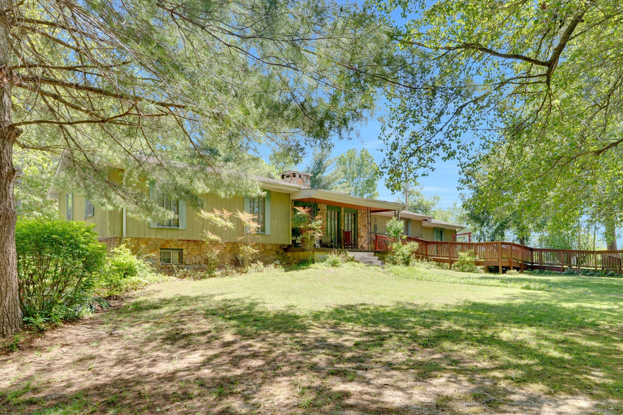 a view of a yard with large trees