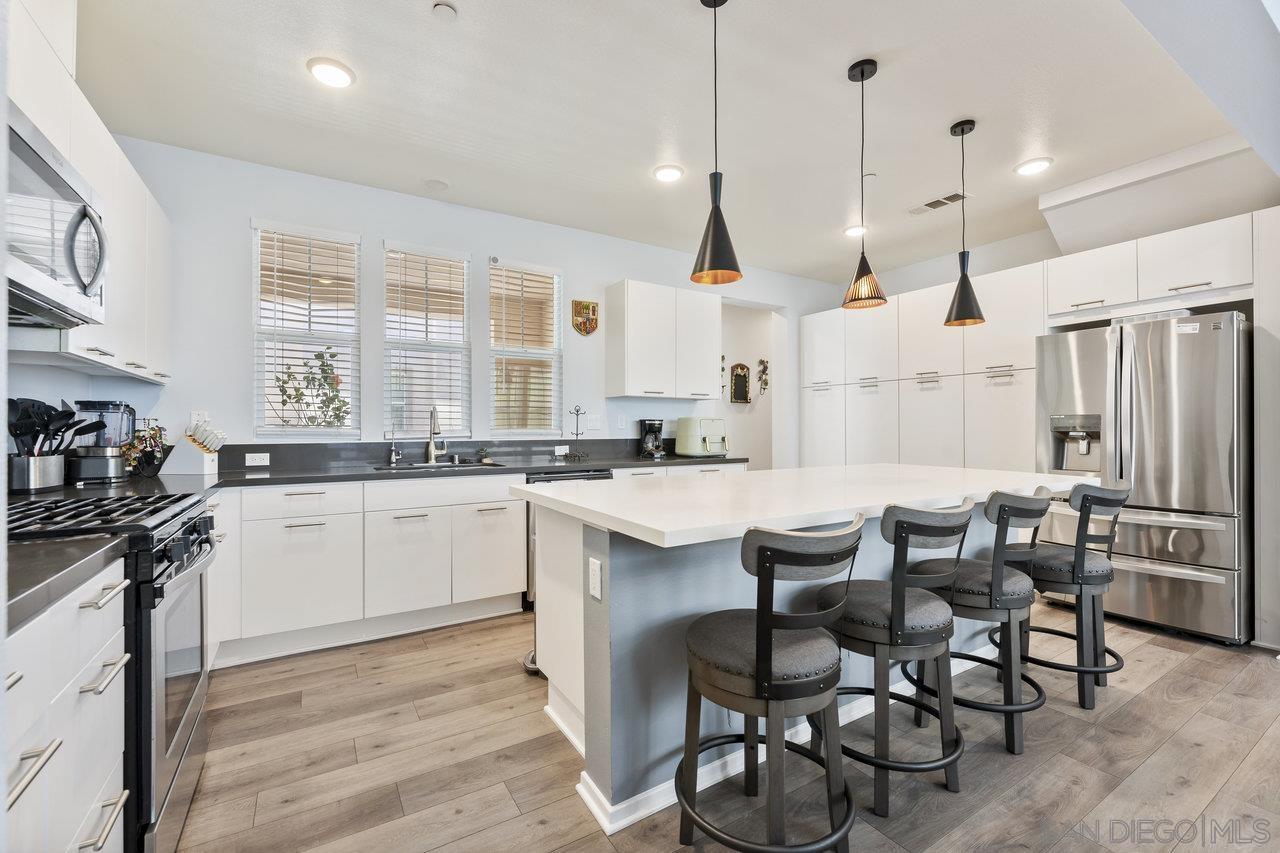 a kitchen with stainless steel appliances kitchen island granite countertop a sink and cabinets