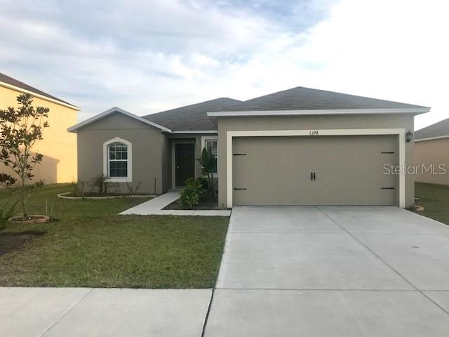 a view of a house with a yard and garage