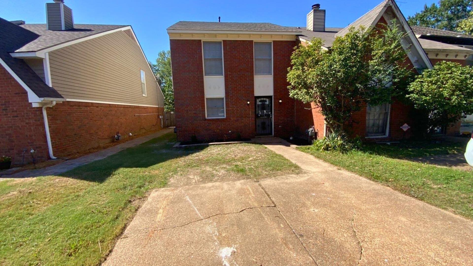 Rear view of property featuring a lawn