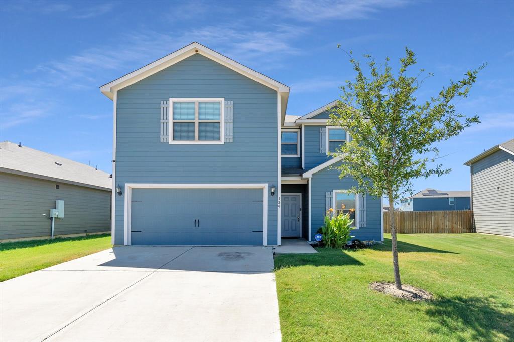 a front view of a house with a yard and garage