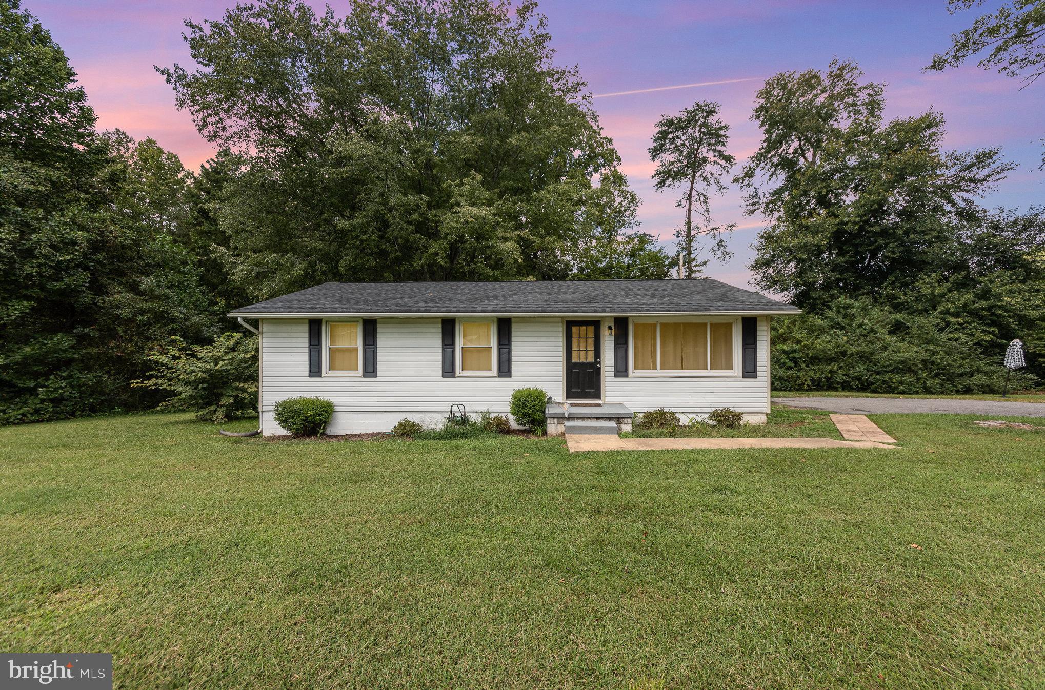 a front view of house with yard and trees