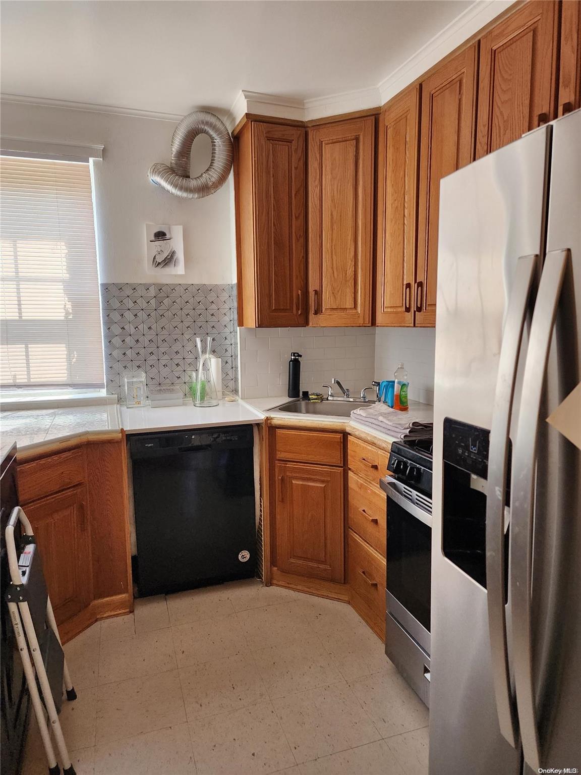 a kitchen with granite countertop a refrigerator stove and sink