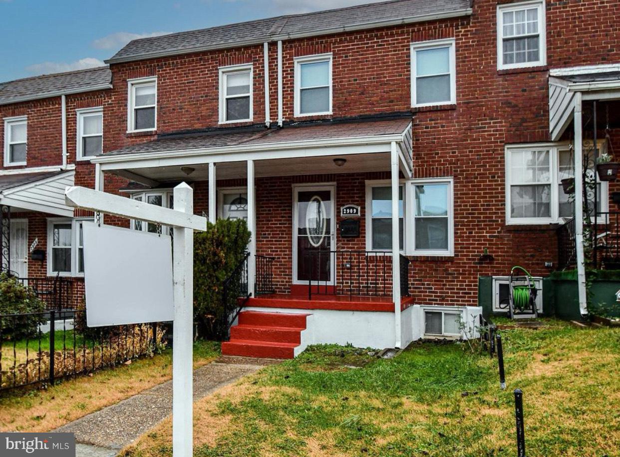 a view of a house with a yard and stairs