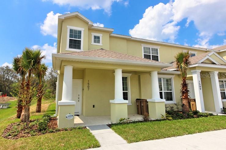 a front view of a house with a yard