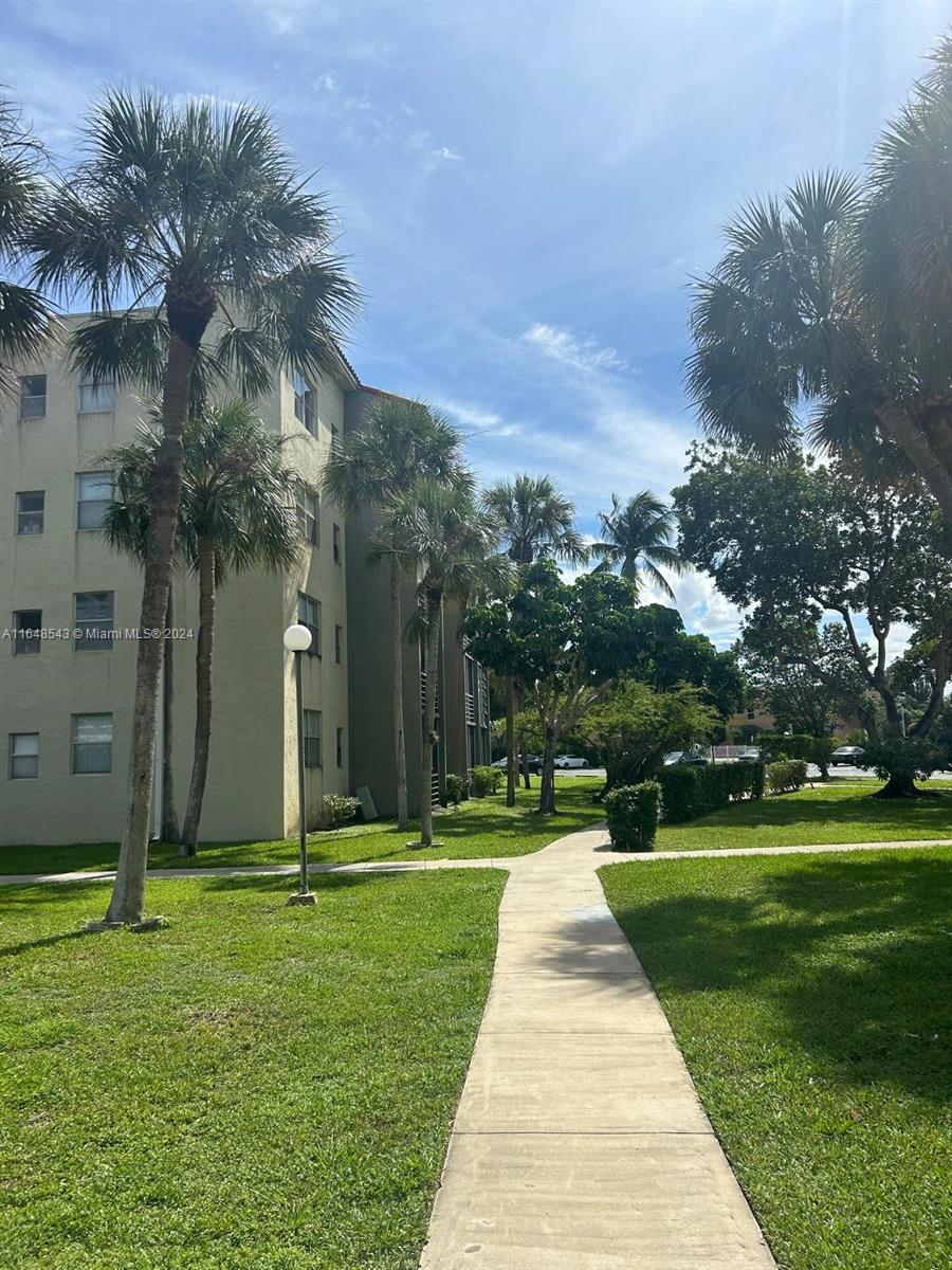 a front view of a building with a yard