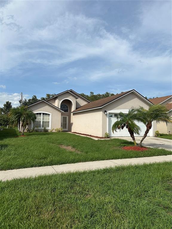 a view of a house with a big yard and potted plants