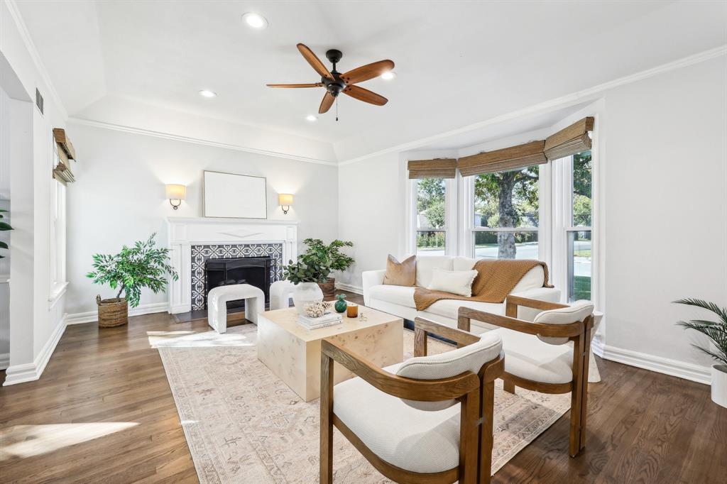 a living room with furniture a fireplace and a potted plant