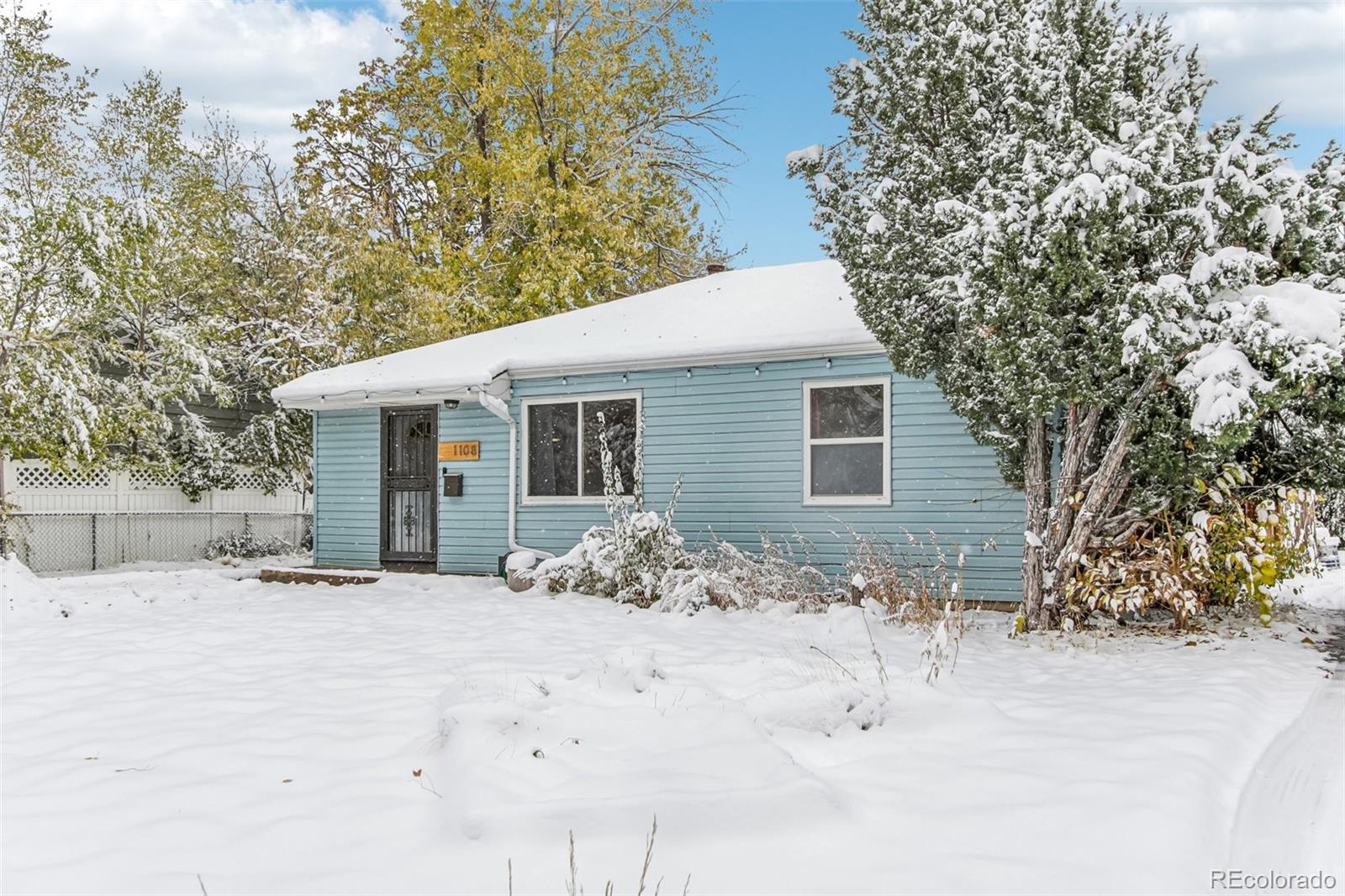 a view of a house with a yard covered in snow