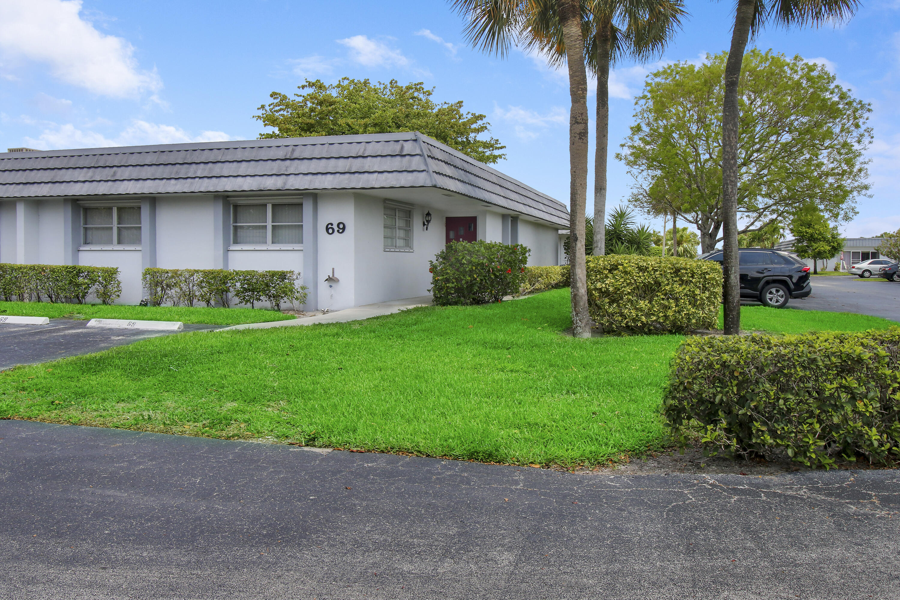 a front view of a house with a garden and yard