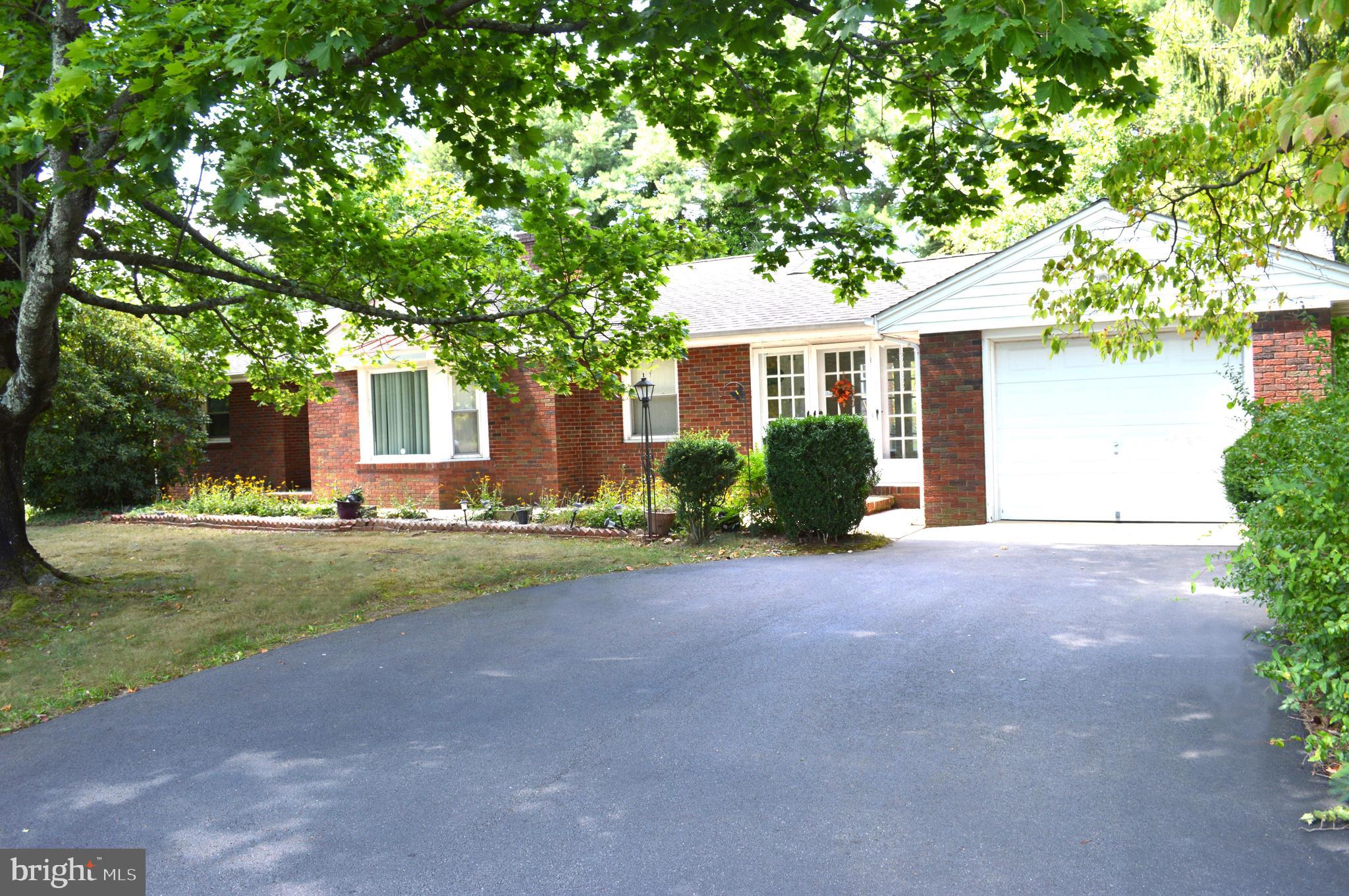 a front view of a house with a yard and a garage