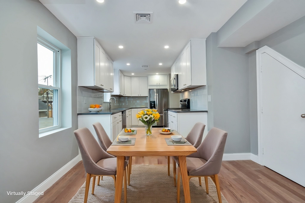 a view of a dining room with furniture and wooden floor