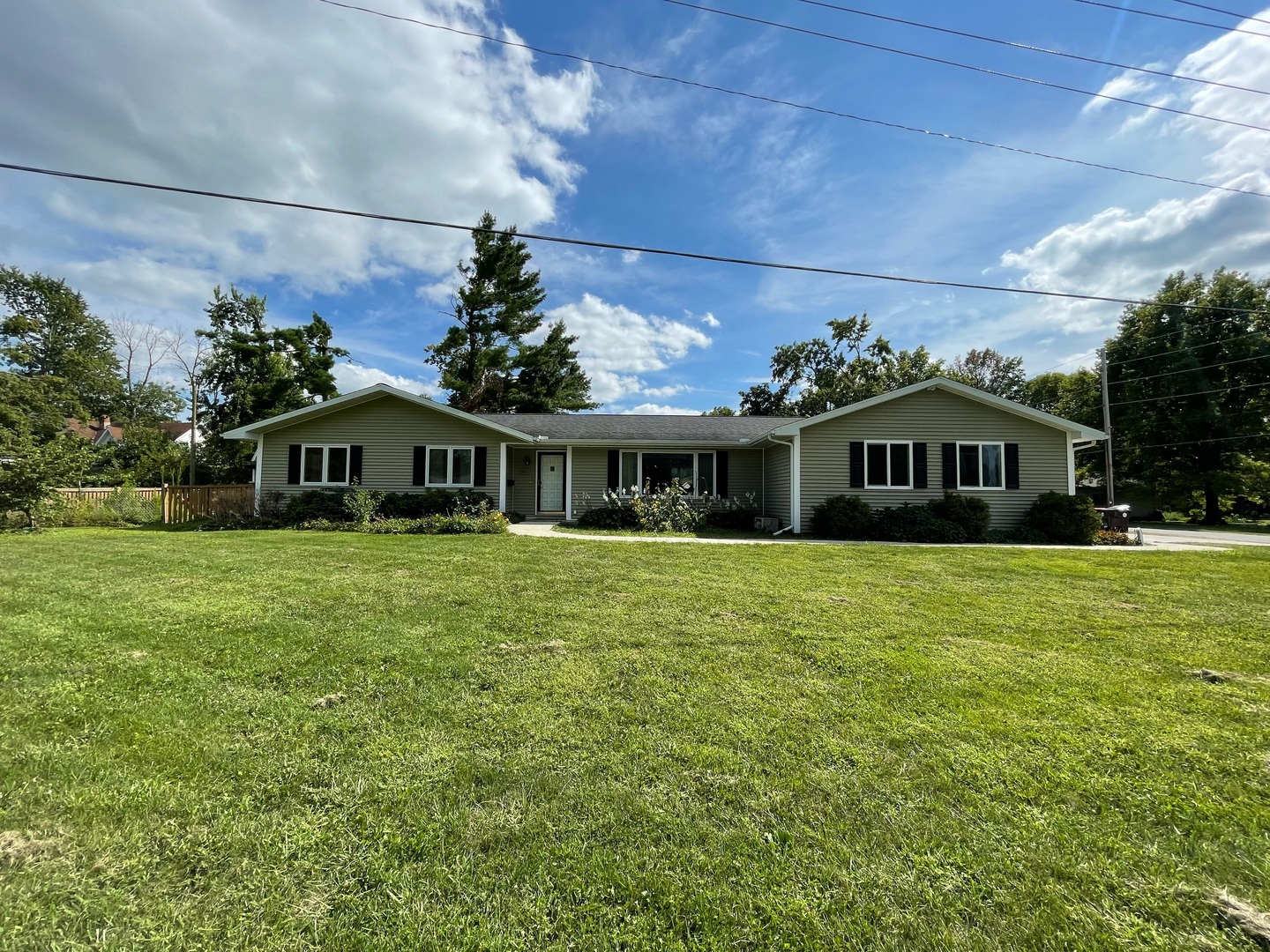 a front view of a house with a garden