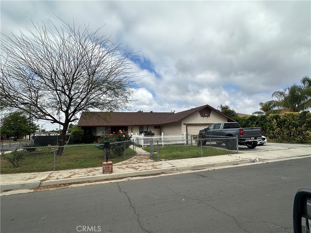 a view of a house with a big yard and large trees