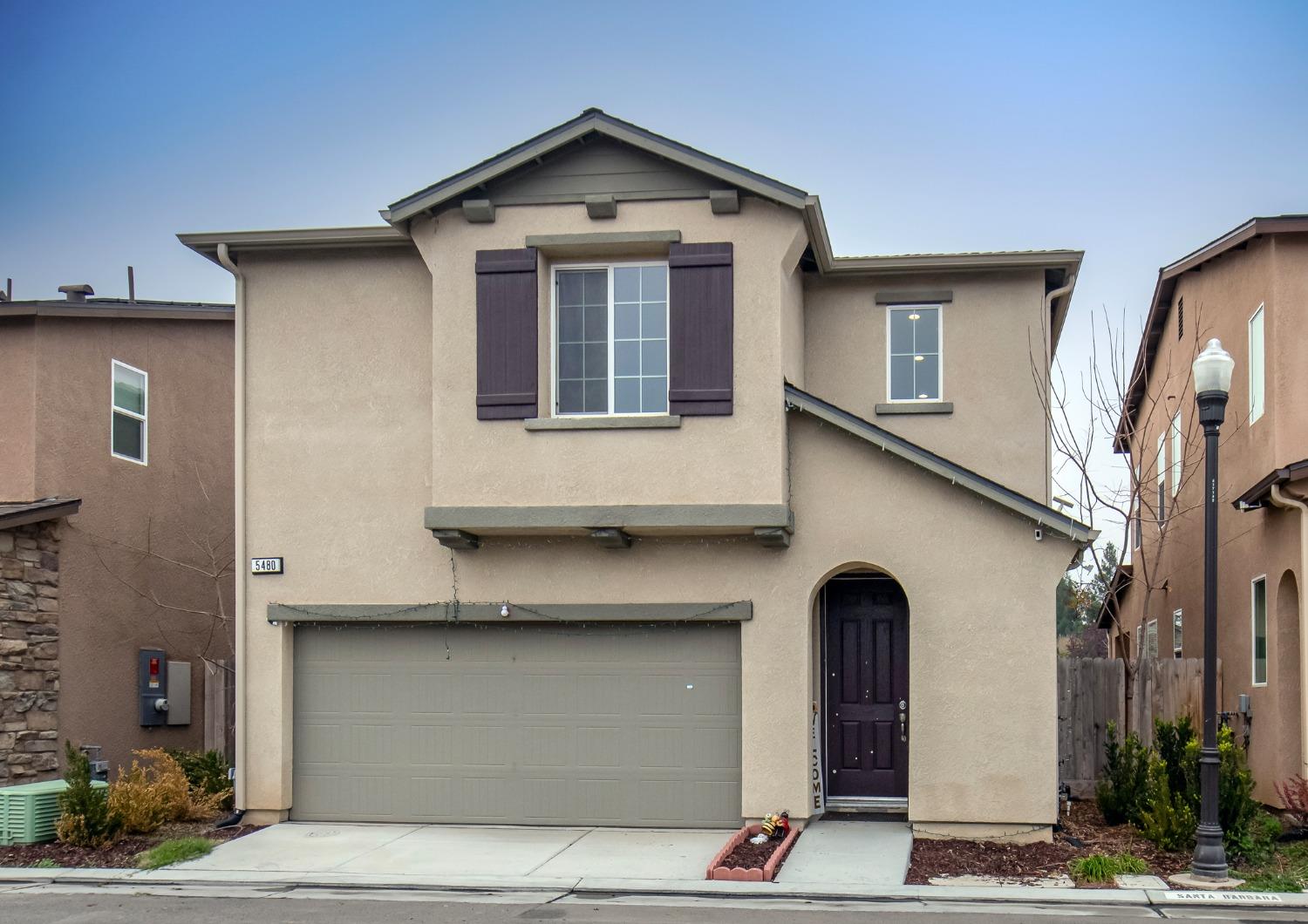 a front view of a house with garage