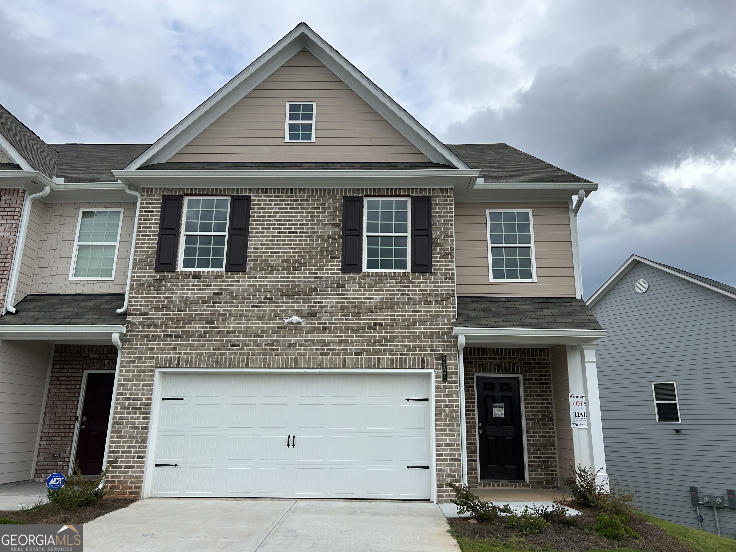 a front view of a house with garage