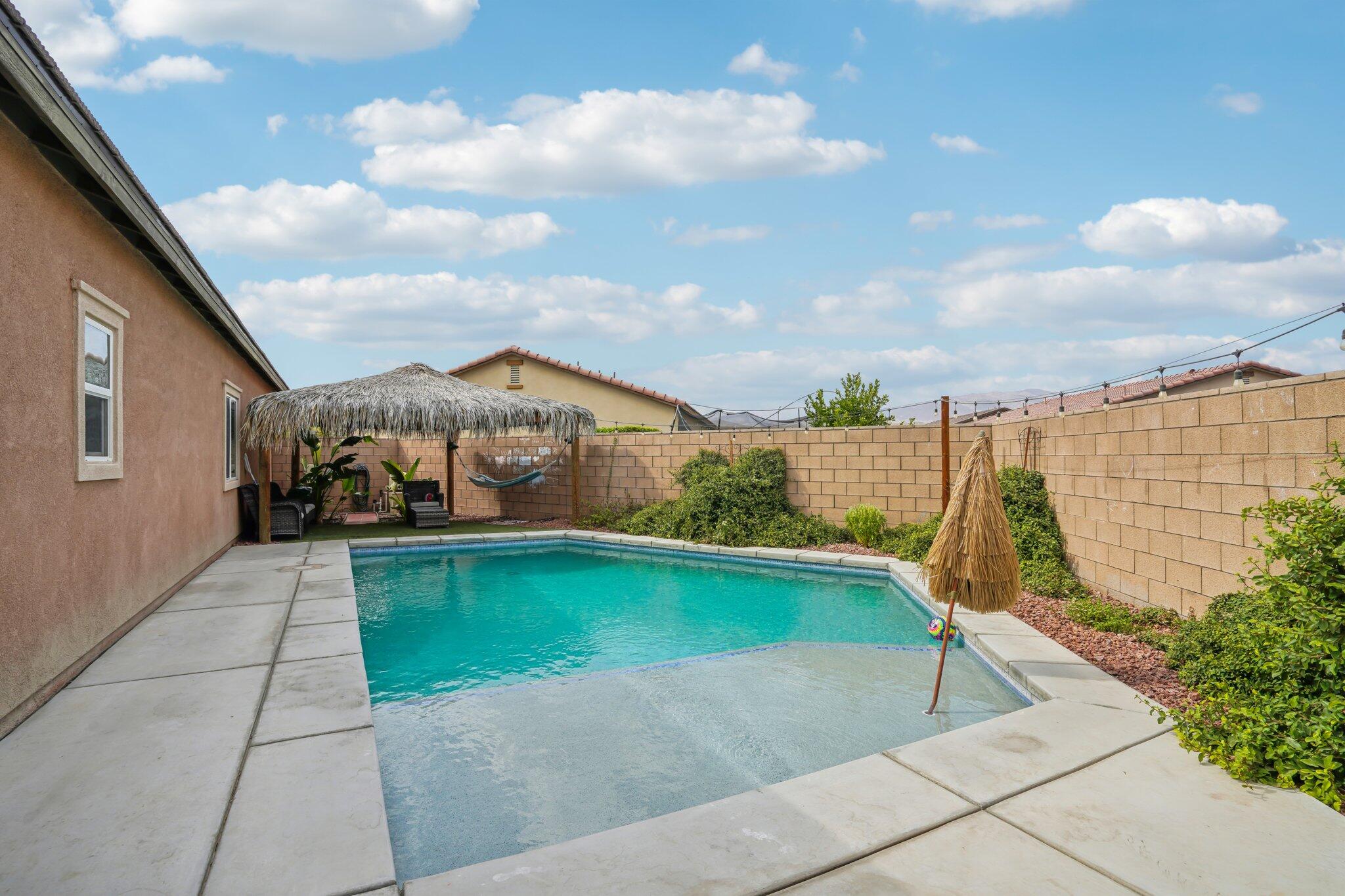 a view of a terrace with a garden and outdoor seating