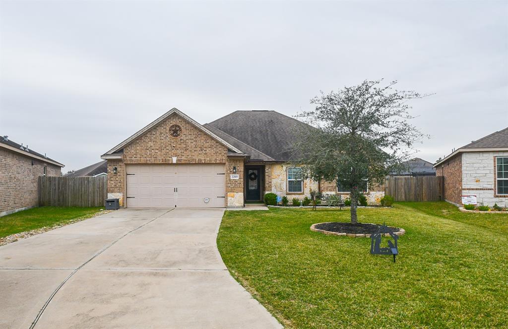 a view of a house with a yard and pathway