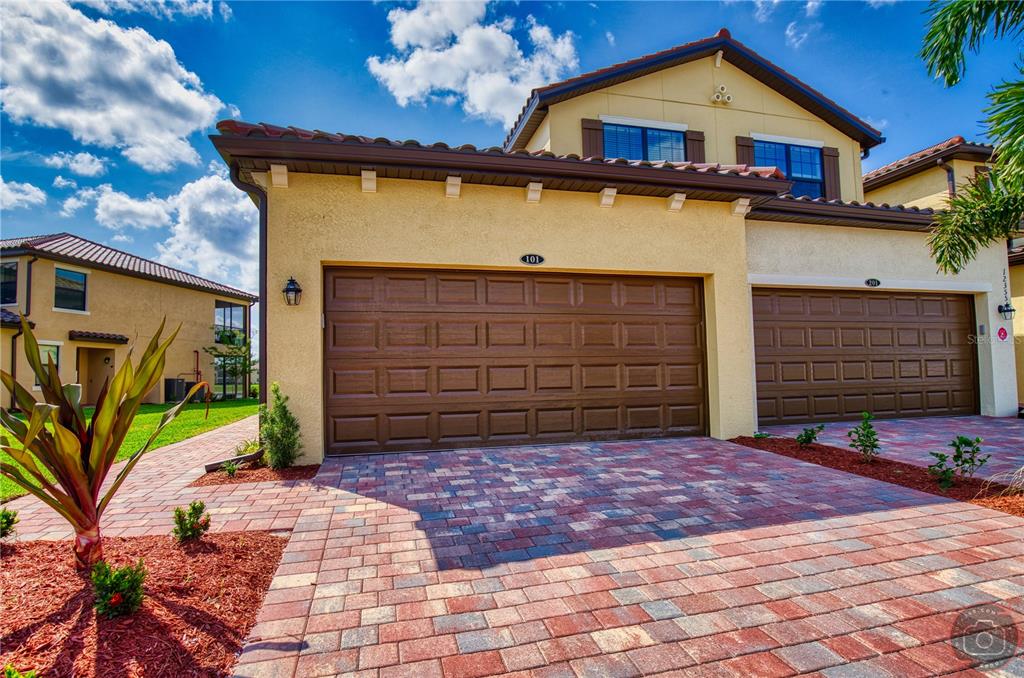 a front view of a house with a yard and garage