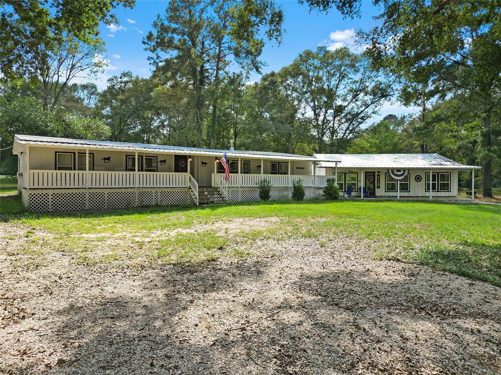 a view of a house with a yard and sitting area