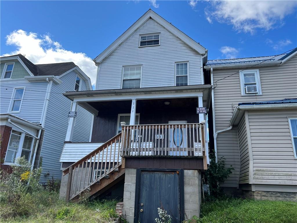 a front view of house along with deck and entertaining space