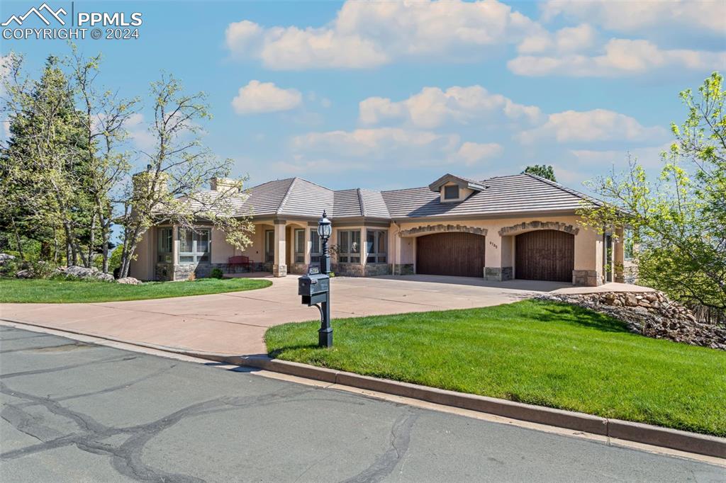 a front view of house with yard and green space