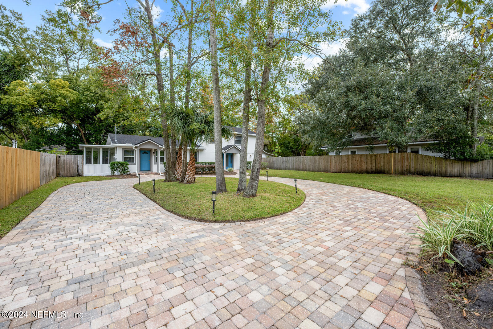 a view of a house with a yard patio and tree