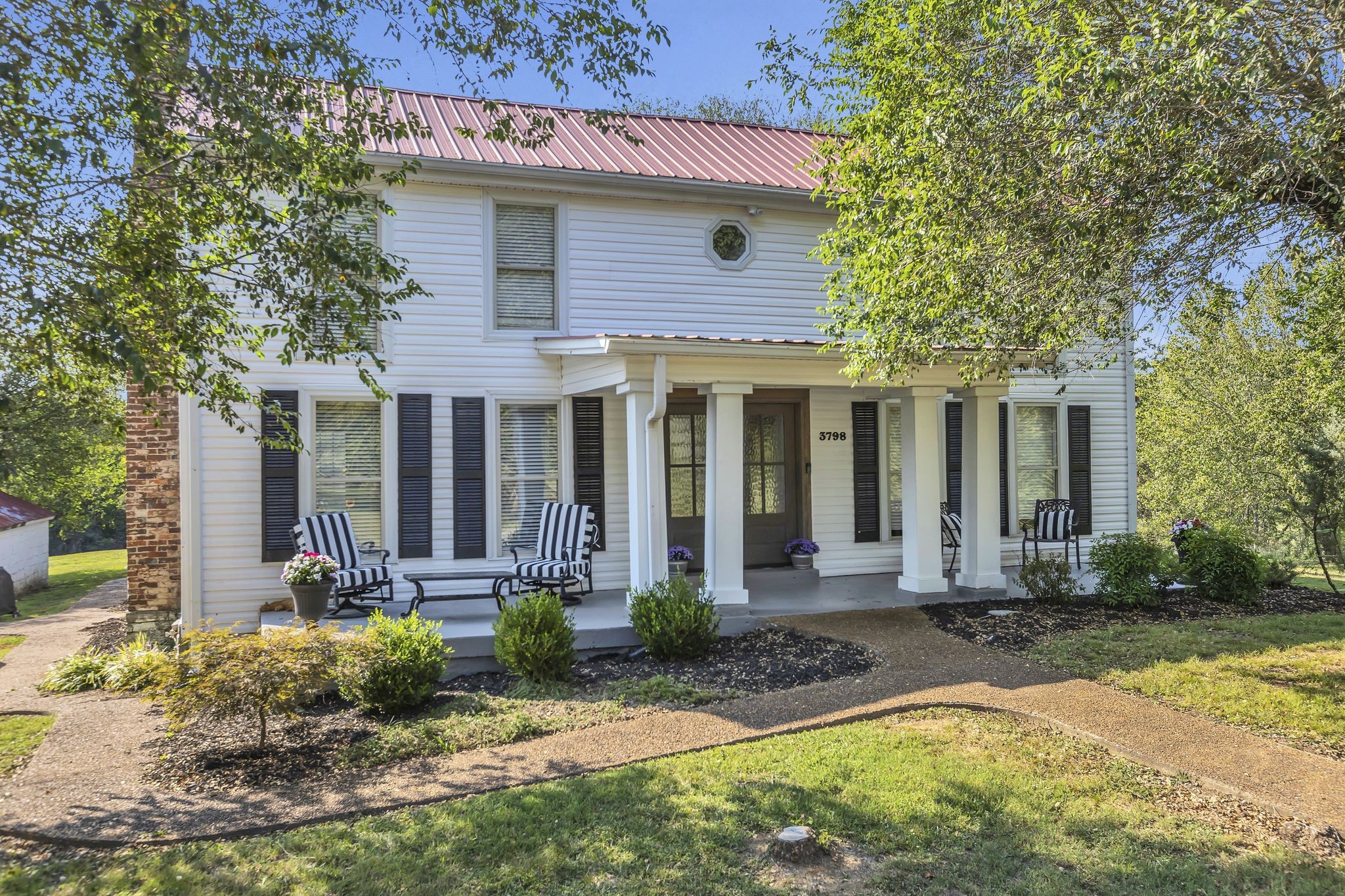 a front view of a house with garden