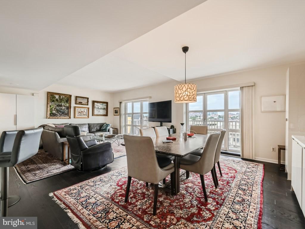 a dining room with furniture a rug and wooden floor