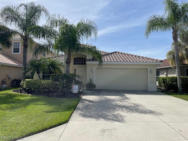 a front view of a house with a garden and palm trees