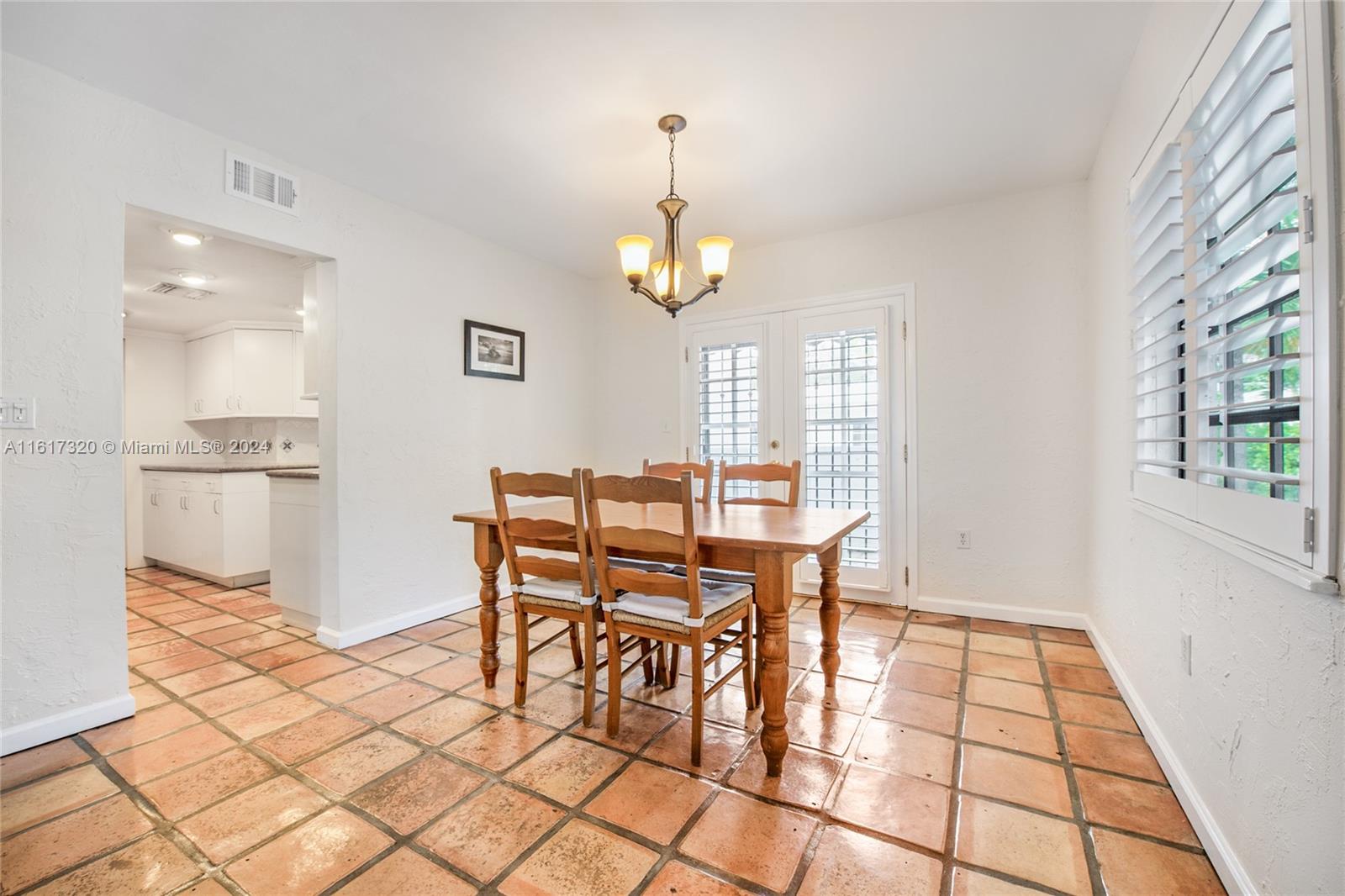 a view of a dining room with furniture and window