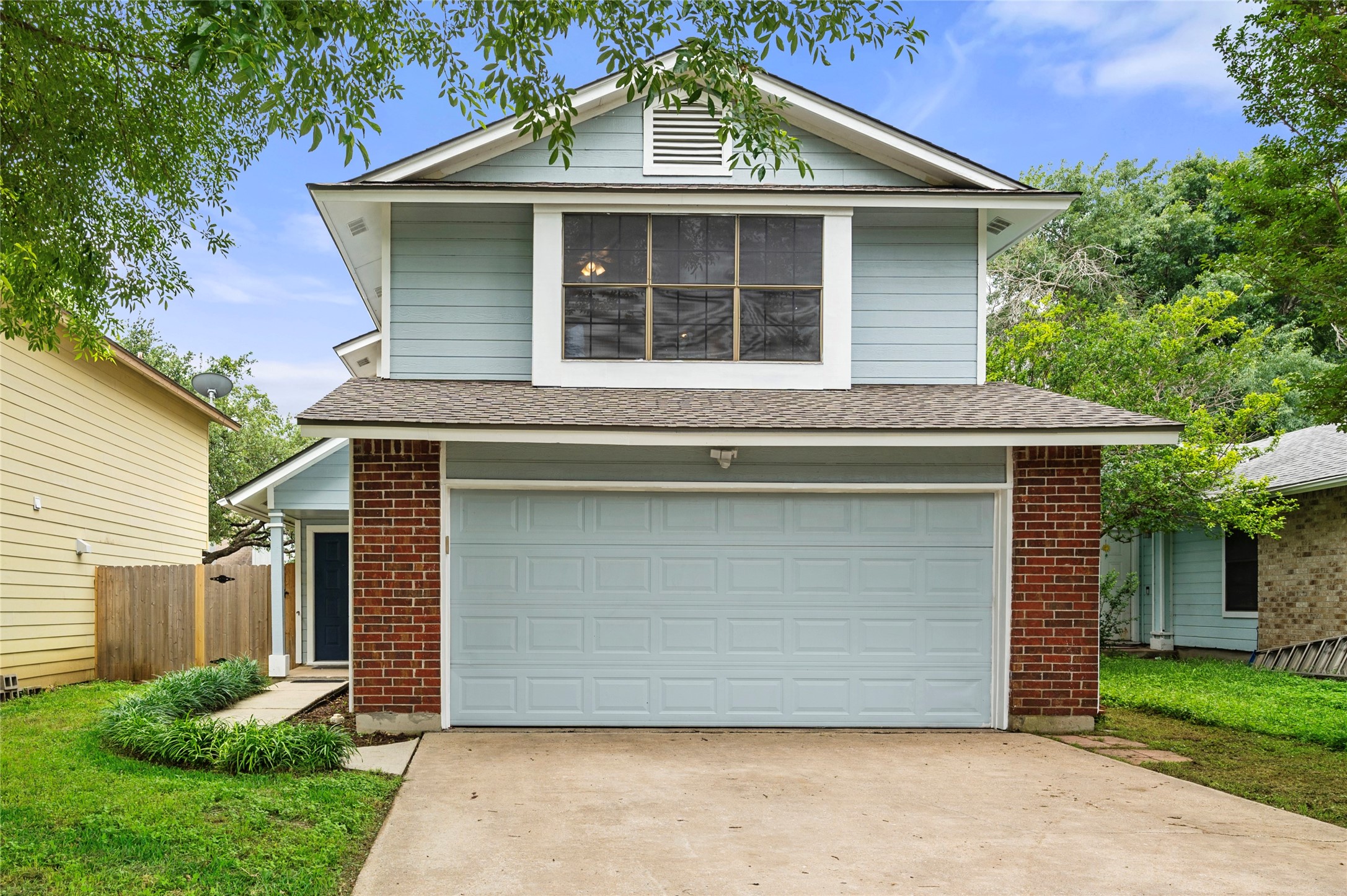 a front view of a house with a garden