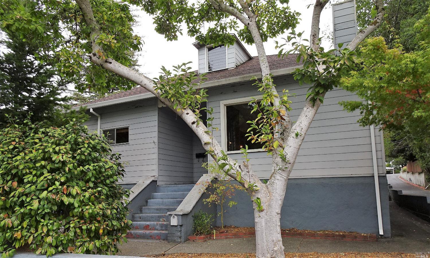 a front view of a house with trees