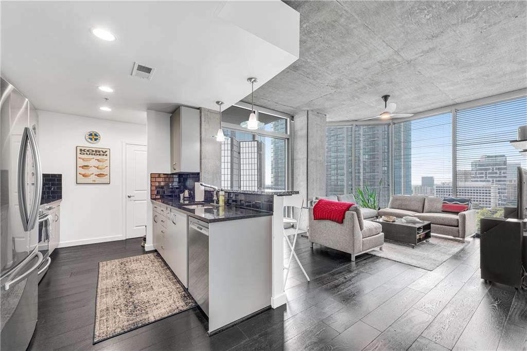 a living room with furniture and a flat screen tv