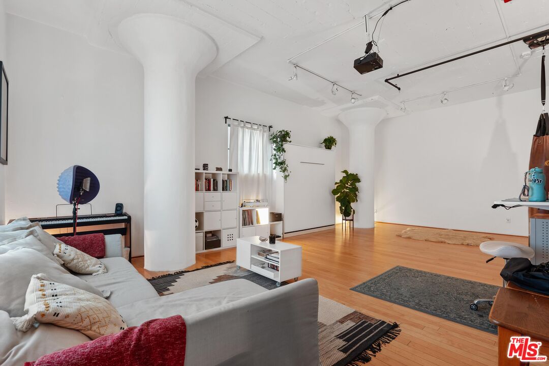 a bedroom with furniture and a wooden floor