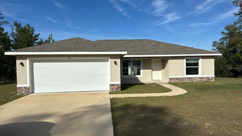 a front view of a house with a yard and garage