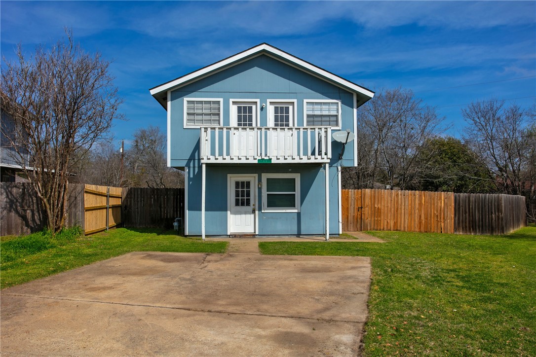 a front view of a house with yard and green space