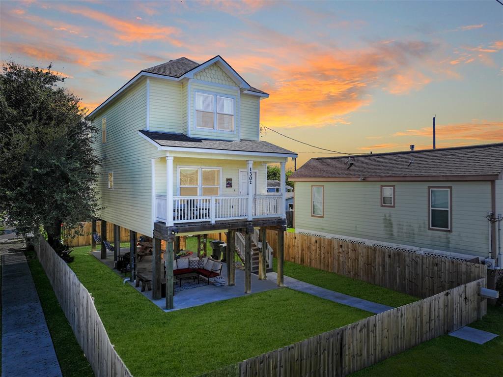 a view of house with a yard and deck