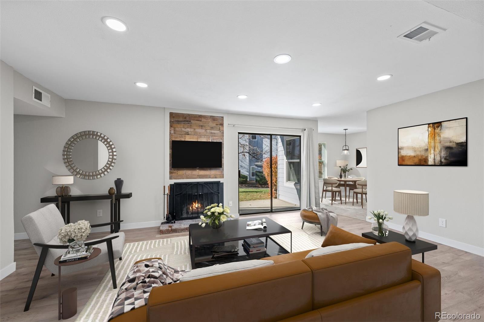 a living room with furniture a flat screen tv and a fireplace