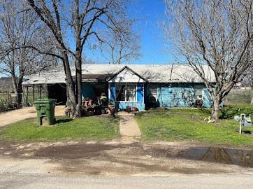 a view of a house with a yard patio and fire pit