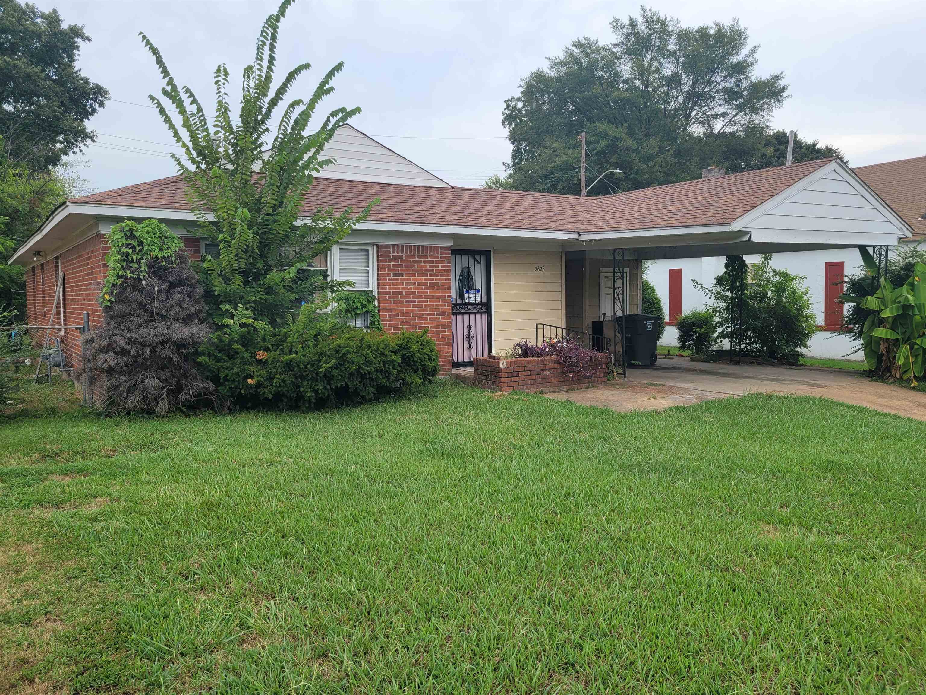 a front view of a house with a yard and porch