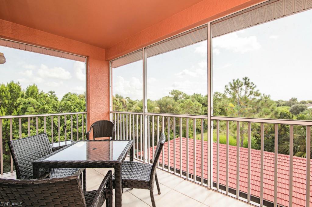 a view of a balcony with a table and chairs