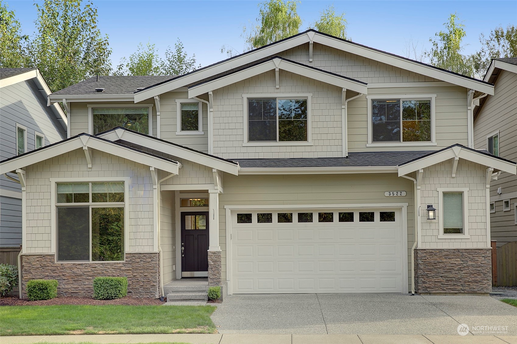 a front view of a house with a yard and garage