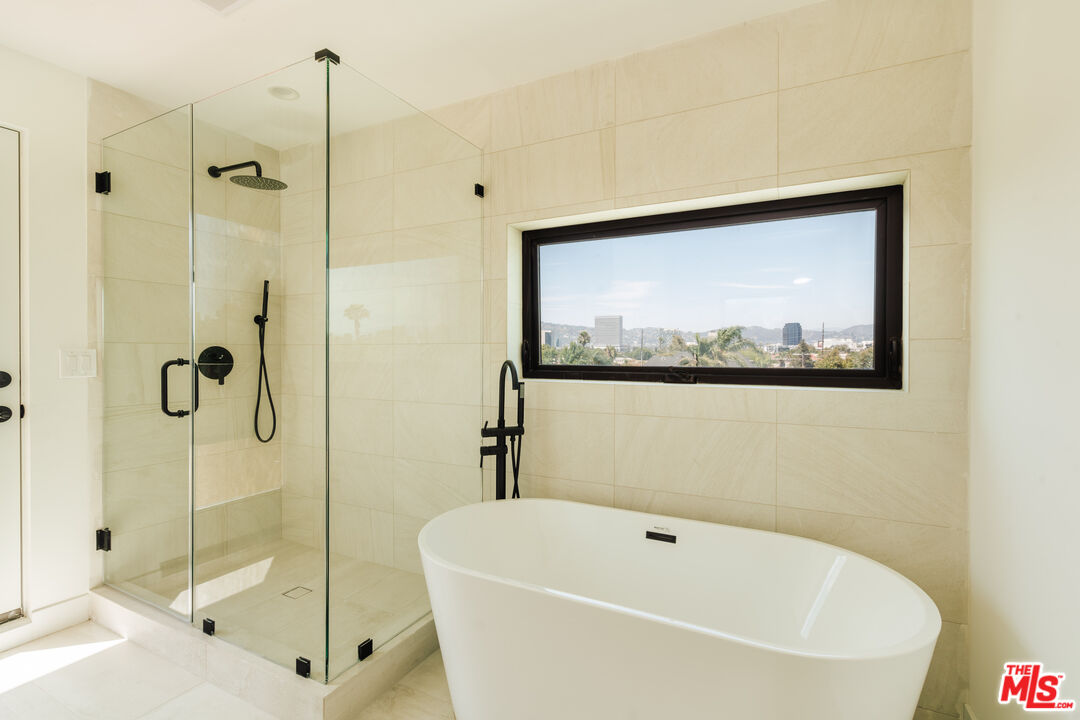 a white bath tub sitting next to a shower