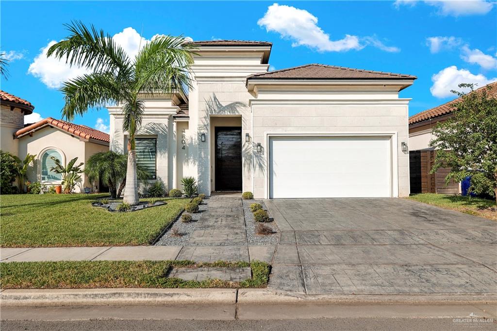 a view of a house with a yard and garage