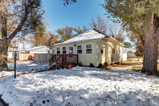 a view of a house with a yard covered in snow