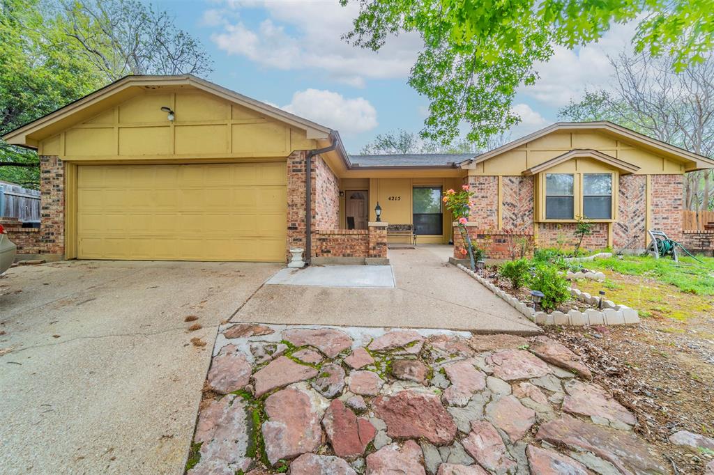 a view of a brick house with a yard