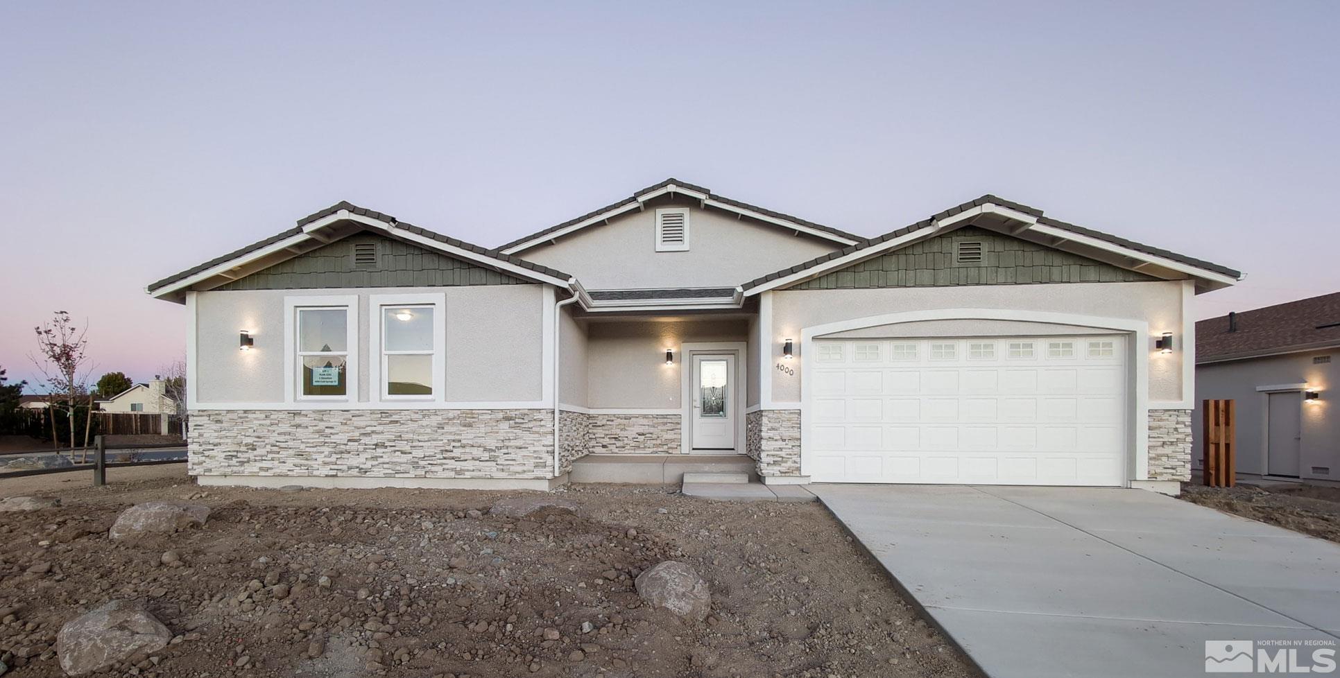 a view of a house with a yard and garage